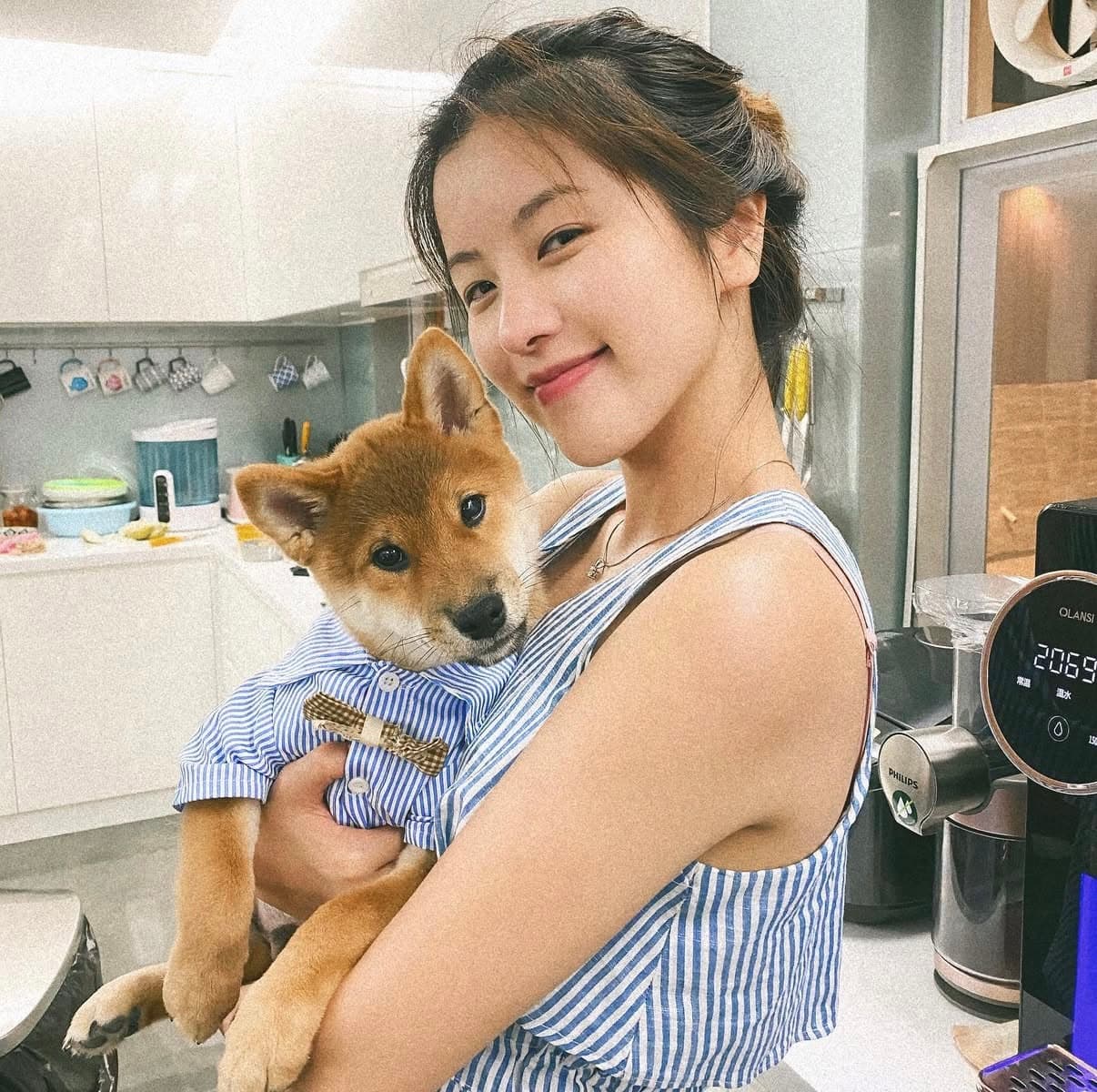 Manise So holding a dog