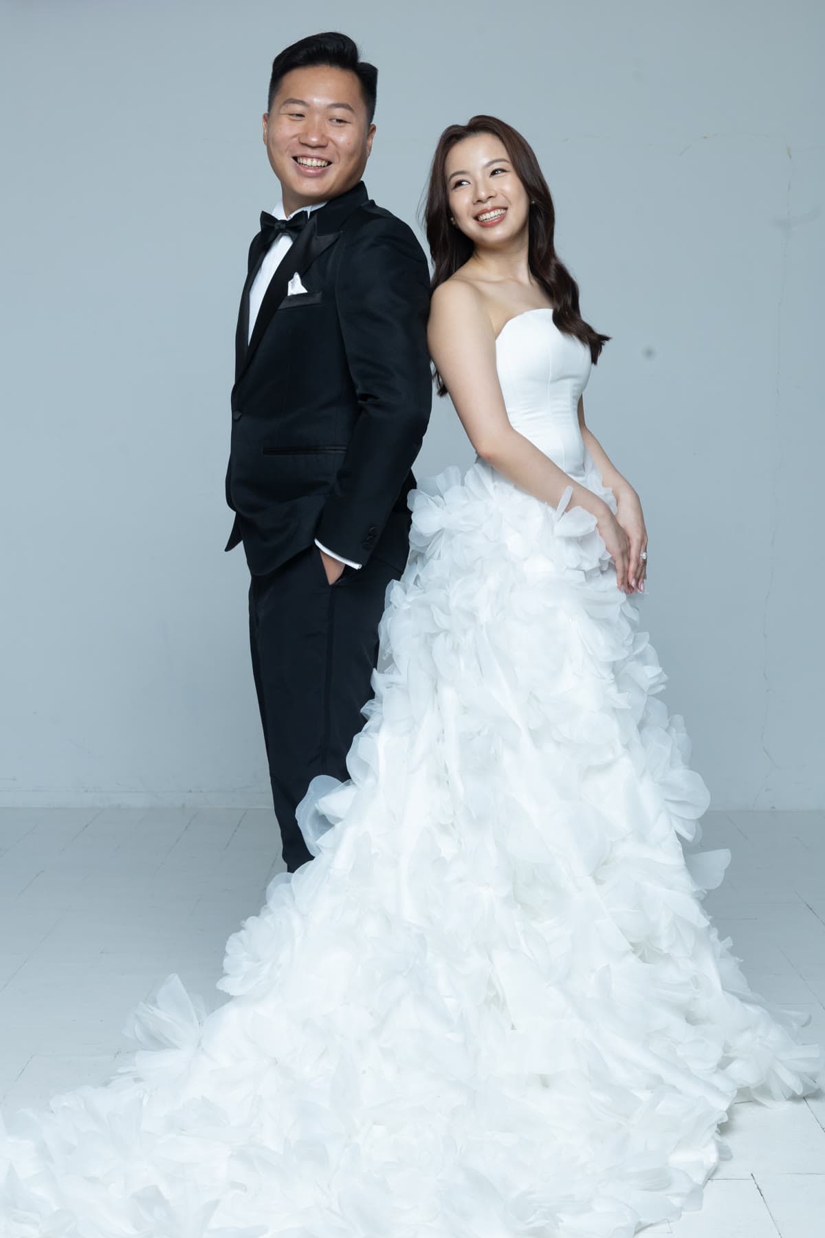 Natalie and Bryan smiling together in formal wedding attire