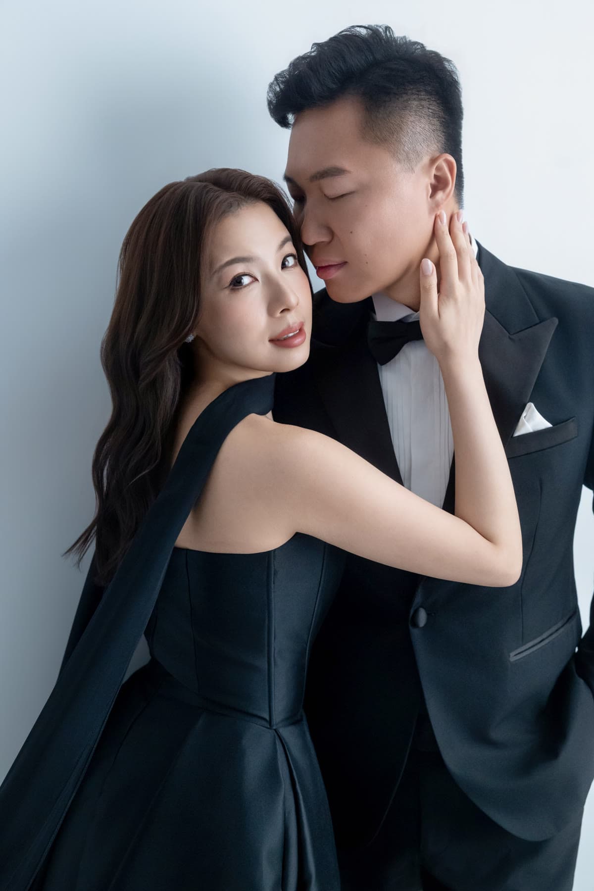 Natalie and Bryan sharing a close moment in black formalwear