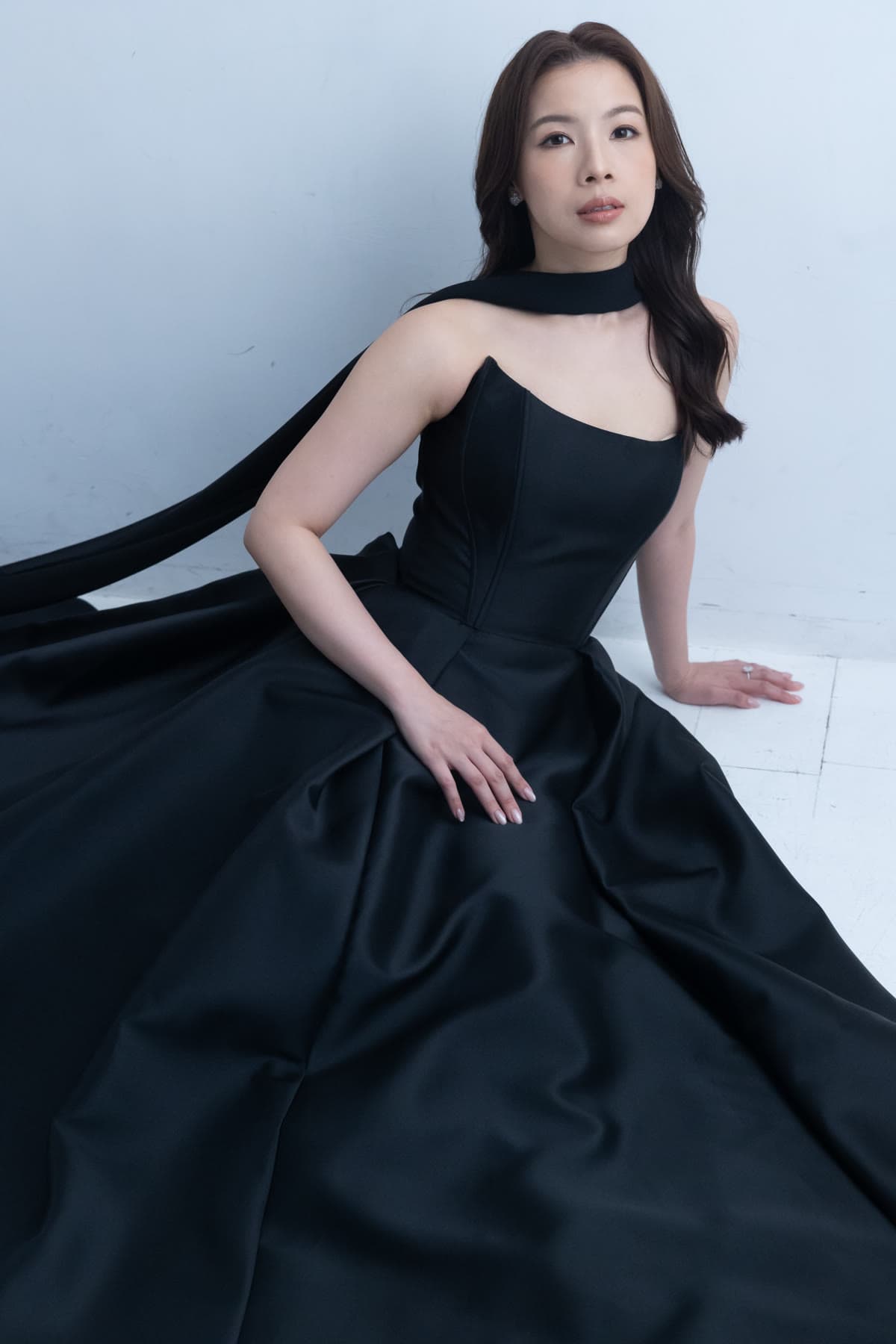 Natalie posing in a sculptural black gown