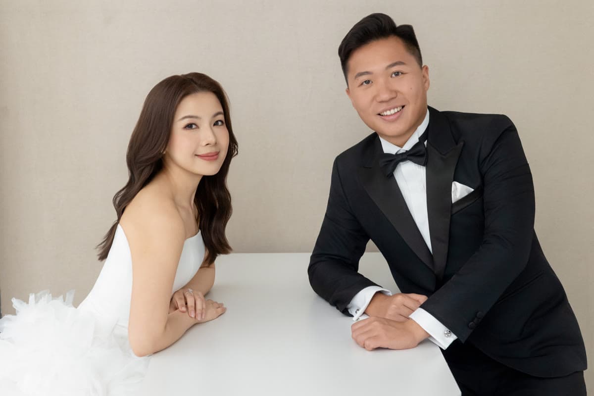 Natalie and Bryan seated together at a white table