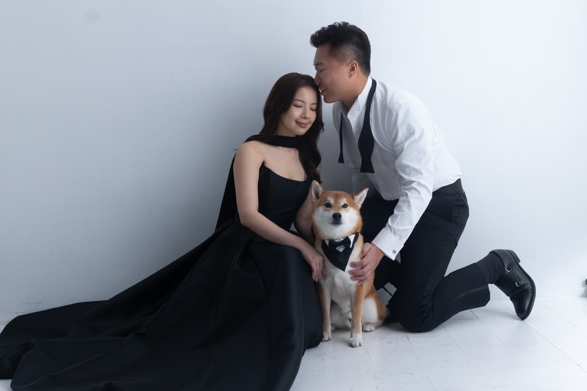 Natalie and Bryan posing playfully with their dog