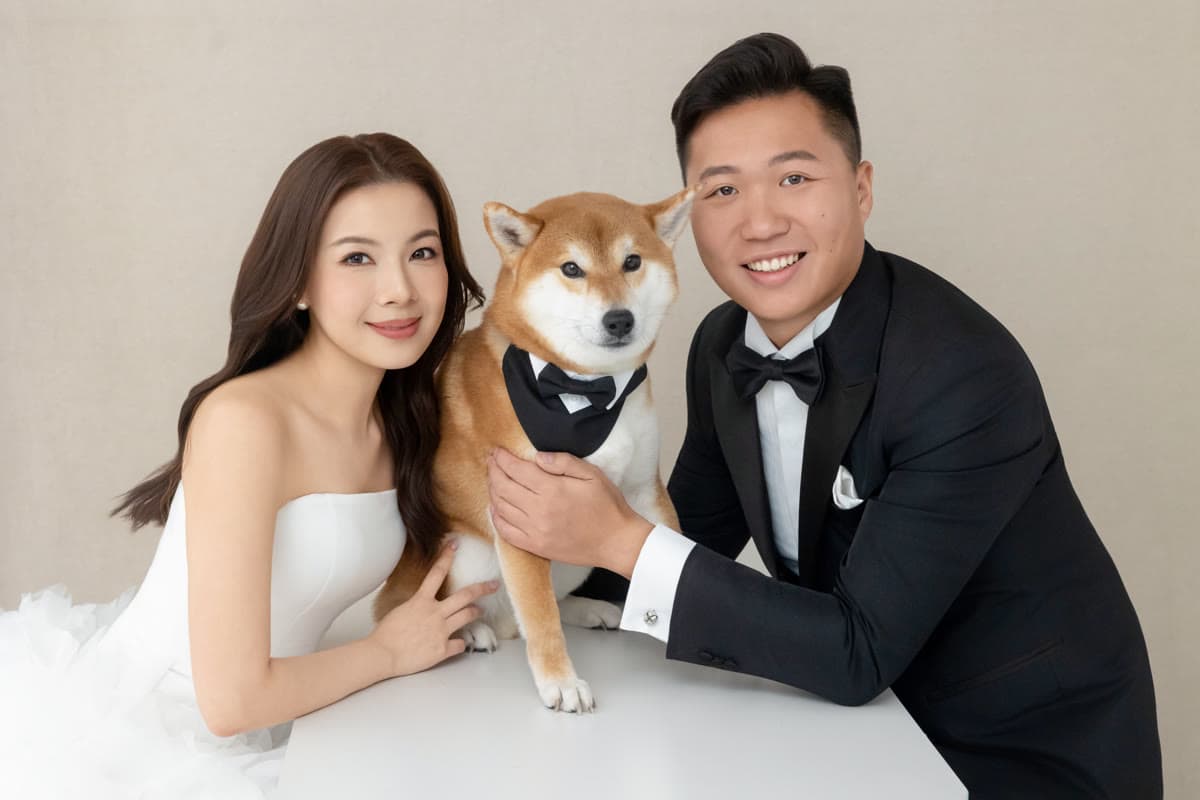 Natalie and Bryan smiling together with their dog