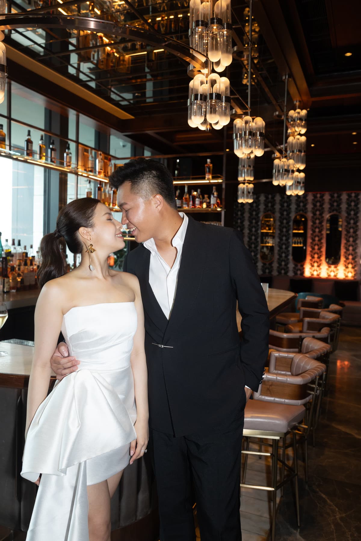 Natalie and Bryan walking together through the bar