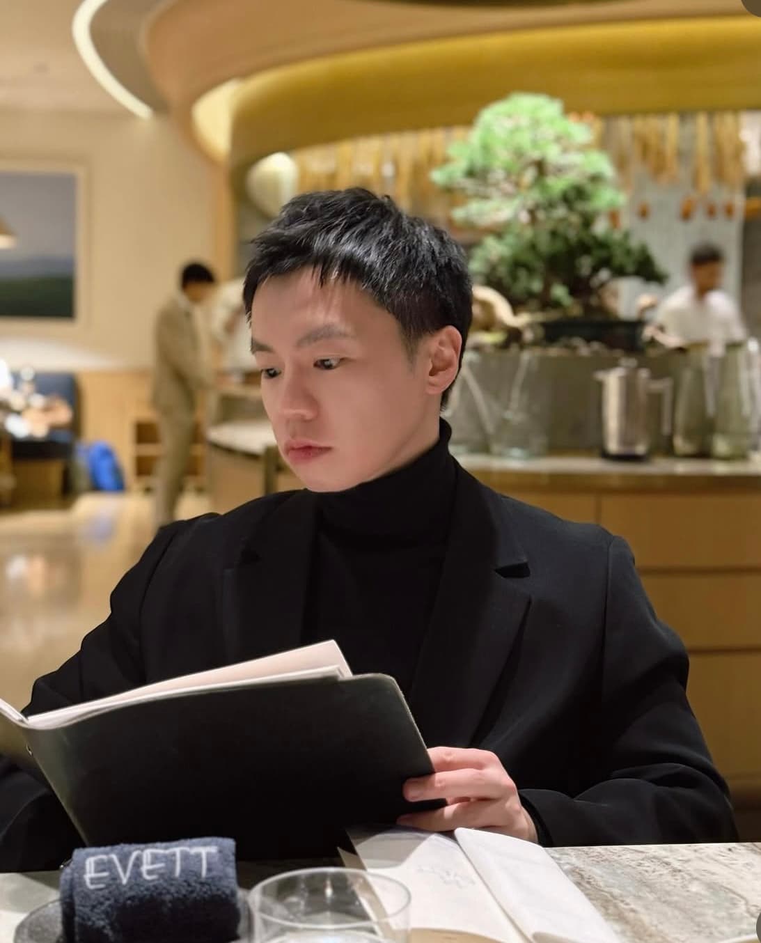 Wilson Wong reading at a restaurant